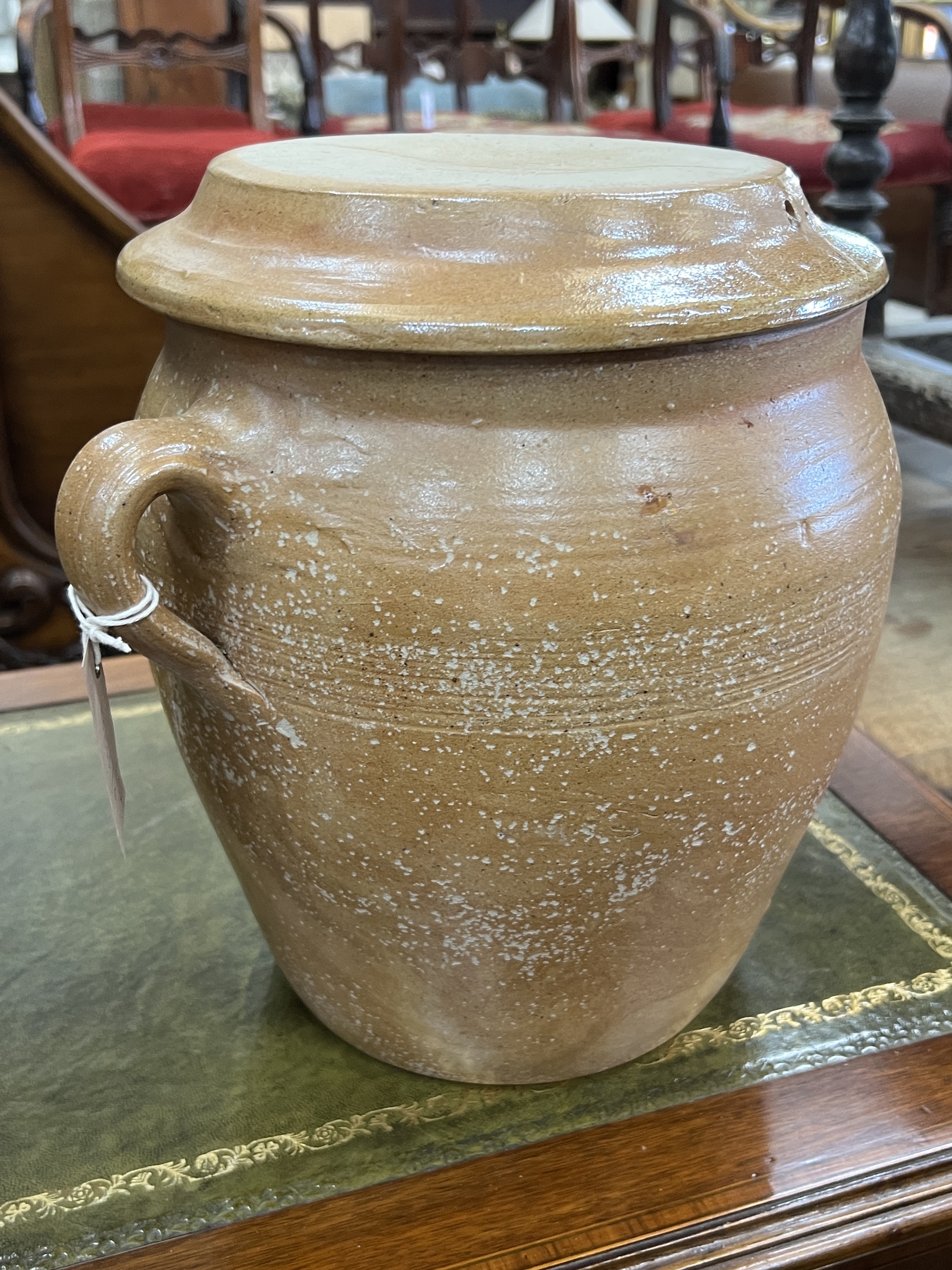 Two salt glazed earthenware circular lidded containers, larger height 49cm